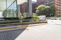 a man is riding a skateboard near an office building in the city or town