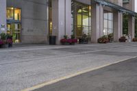 a person riding a skateboard on a street near a building in the evening with clouds