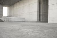 a man that is skateboarding outside of a building on concrete floors that are set up