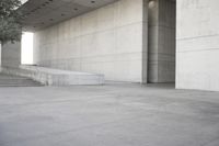 a man that is skateboarding outside of a building on concrete floors that are set up