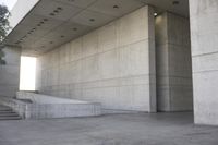 a man that is skateboarding outside of a building on concrete floors that are set up