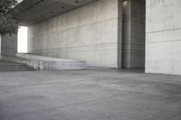 a man that is skateboarding outside of a building on concrete floors that are set up