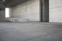 a man that is skateboarding outside of a building on concrete floors that are set up