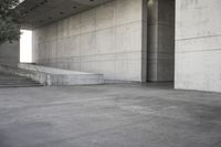 a man that is skateboarding outside of a building on concrete floors that are set up