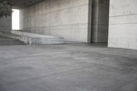 a man that is skateboarding outside of a building on concrete floors that are set up