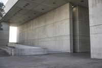 a man that is skateboarding outside of a building on concrete floors that are set up