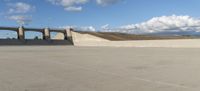 a man with a skateboard riding over an overpass on top of cement barriers