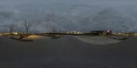 skateboarding at a skateboard park with a snow bank and lights in the background