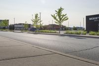 a man wearing glasses is riding on a skateboard on a paved street in front of a sign that says mckinss