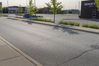 a man wearing glasses is riding on a skateboard on a paved street in front of a sign that says mckinss