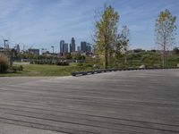 a skateboarder at the edge of a wooden ramp looking at city skylines