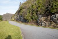 the shadow of a person on a skateboard near a scenic landscape with large cliffs and trees