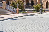 a person riding on a skateboard in a brick walkway way near a tall building