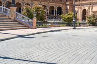 a person riding on a skateboard in a brick walkway way near a tall building