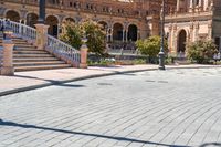 a person riding on a skateboard in a brick walkway way near a tall building