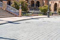 a person riding on a skateboard in a brick walkway way near a tall building