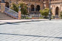 a person riding on a skateboard in a brick walkway way near a tall building