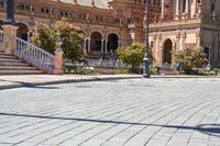 a person riding on a skateboard in a brick walkway way near a tall building