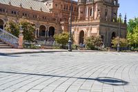 a person riding on a skateboard in a brick walkway way near a tall building