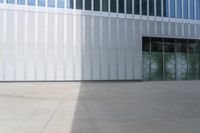 a man is skateboarding outside of an office building at the day time in this photo