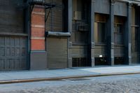 a man on a skateboard on the side of a street in a city alley
