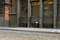 a man on a skateboard on the side of a street in a city alley