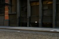 a man on a skateboard on the side of a street in a city alley
