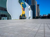 a statue of a man on a skateboard stands in front of the building's entrance