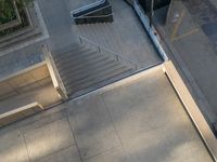 this photo shows a skateboarder who is going down the steps outside the building