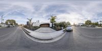 a skateboarder is trying to slide a half pipe in a neighborhood on a sunny day