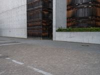 a guy is on a skateboard near the wall outside of an office building in tokyo