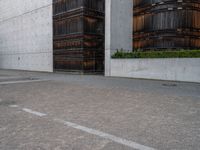 a guy is on a skateboard near the wall outside of an office building in tokyo