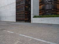 a guy is on a skateboard near the wall outside of an office building in tokyo