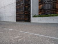 a guy is on a skateboard near the wall outside of an office building in tokyo