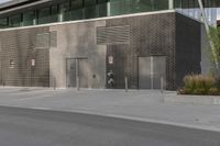 a person on a skateboard in front of a large building with a lot of windows