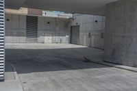 a man riding a skateboard on the side of a concrete sidewalk next to a street