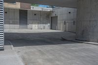 a man riding a skateboard on the side of a concrete sidewalk next to a street