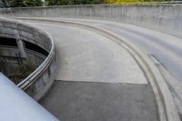 two people on skateboards in the skate park with ramps that are almost round and have two sections that are curved