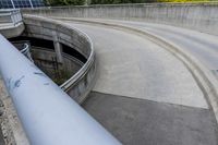 two people on skateboards in the skate park with ramps that are almost round and have two sections that are curved