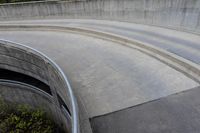 two people on skateboards in the skate park with ramps that are almost round and have two sections that are curved