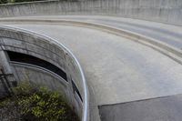 two people on skateboards in the skate park with ramps that are almost round and have two sections that are curved