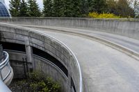 two people on skateboards in the skate park with ramps that are almost round and have two sections that are curved