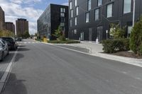 the man is skateboarding down the empty street by himself, in a parking lot