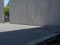 a person doing a trick on the skateboard in the cement park or outside the building