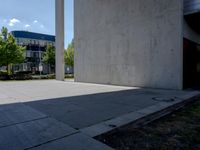 a person doing a trick on the skateboard in the cement park or outside the building