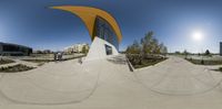 a view from inside the fisheye lens of a skateboarder doing tricks at the park