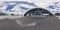 a bridge is pictured as a skateboarder rides on a ramp in a photo