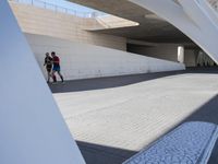 the young woman is skate boarding under an overpass in the city underpasss are also very easy to do