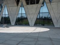 this is an image of a man riding a skateboard outside a building with a large window