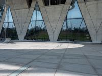 this is an image of a man riding a skateboard outside a building with a large window